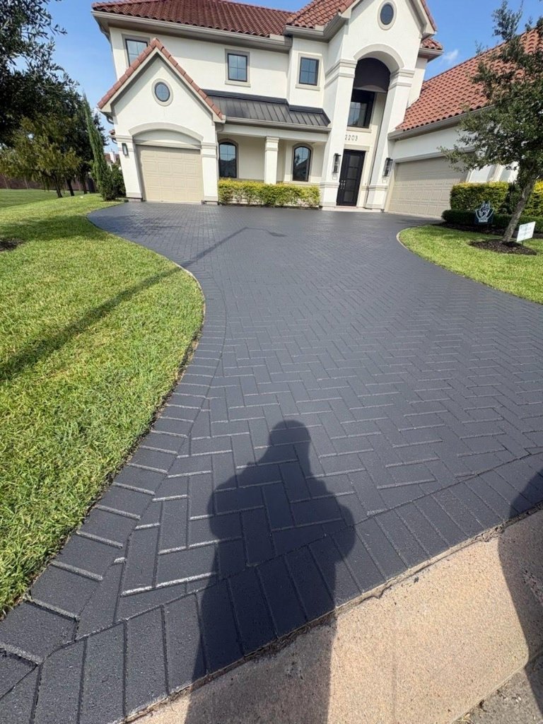 Sweeping curved paver driveway with custom radius edge border