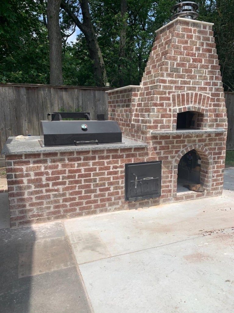 Handcrafted brick pizza oven and BBQ smoker masonry station