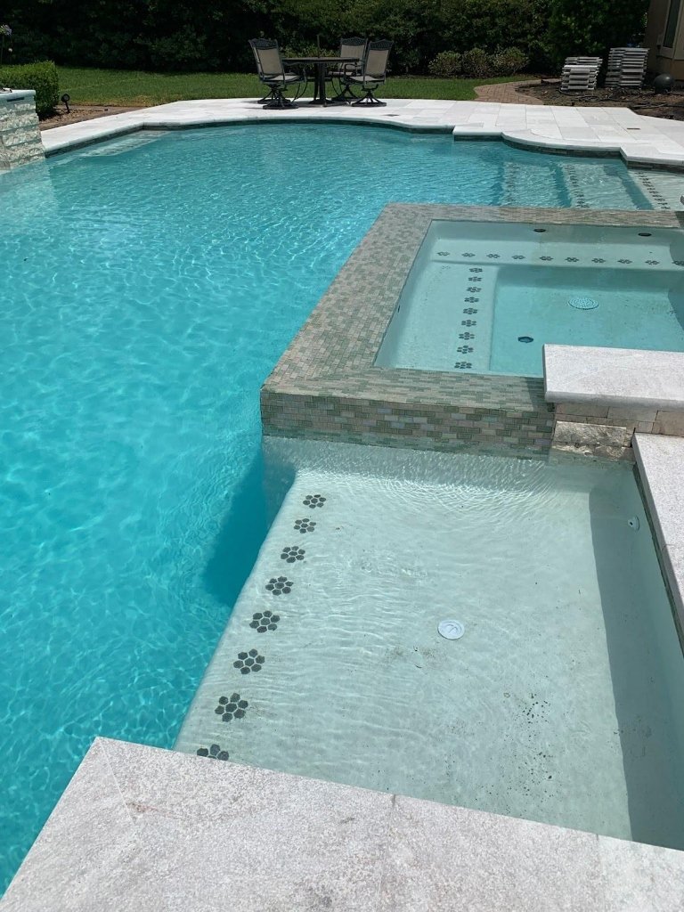 Resort style travertine pool deck and natural stone coping